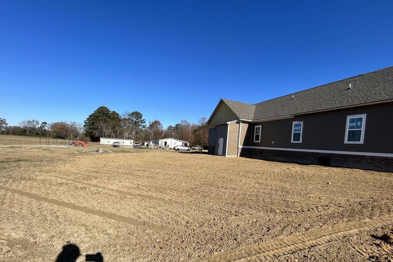 Large graded building pad in front of a metal building