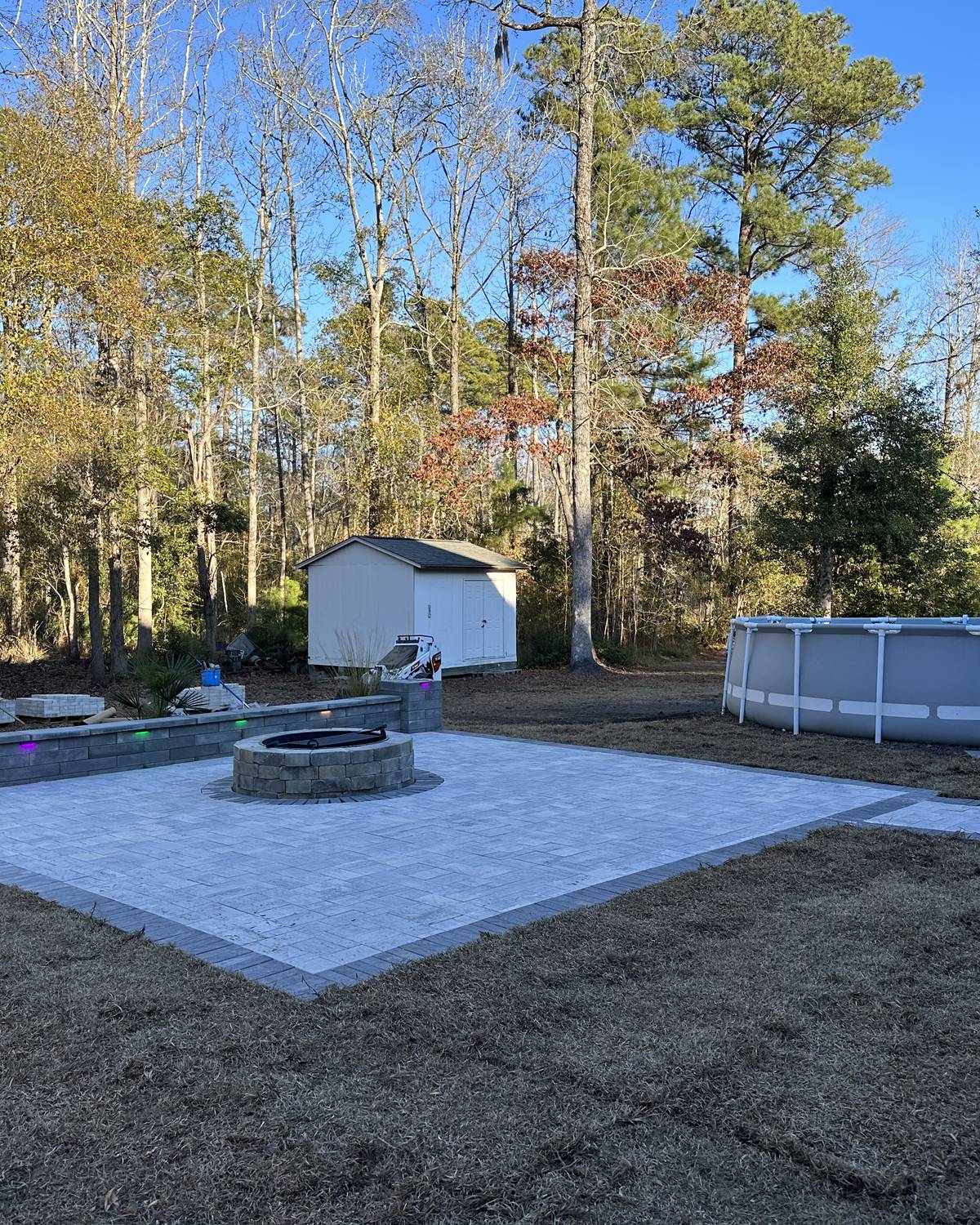 The finished patio and fire pit seen wide across the yard